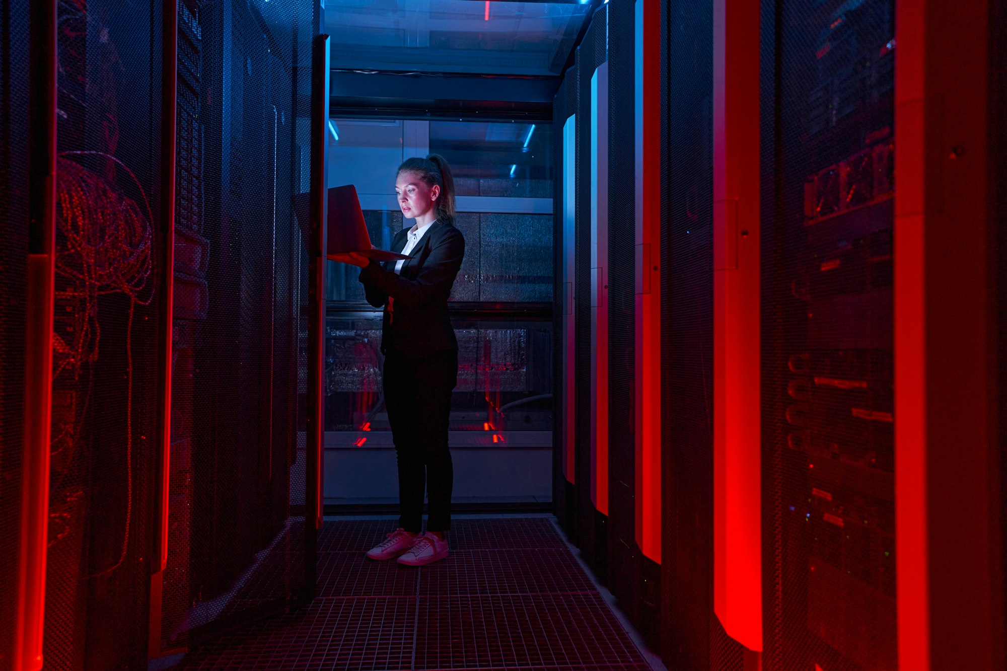 Woman working on servers in data center